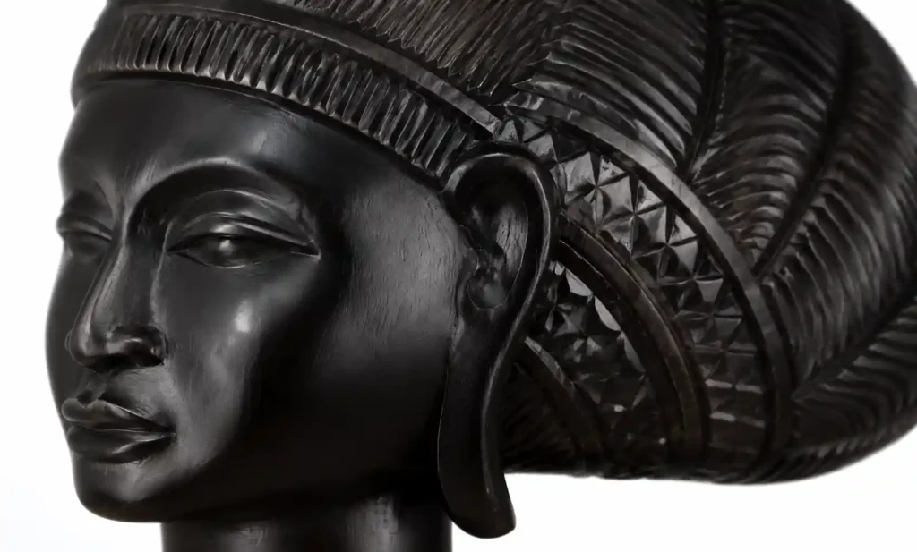Close-up of polished ebony wood carving showing jet black color and fine grain detail