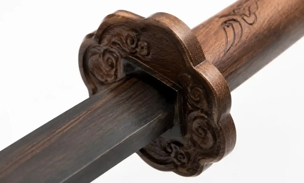 Close-up of hand-carved wooden sword guard showing detail quality and joinery