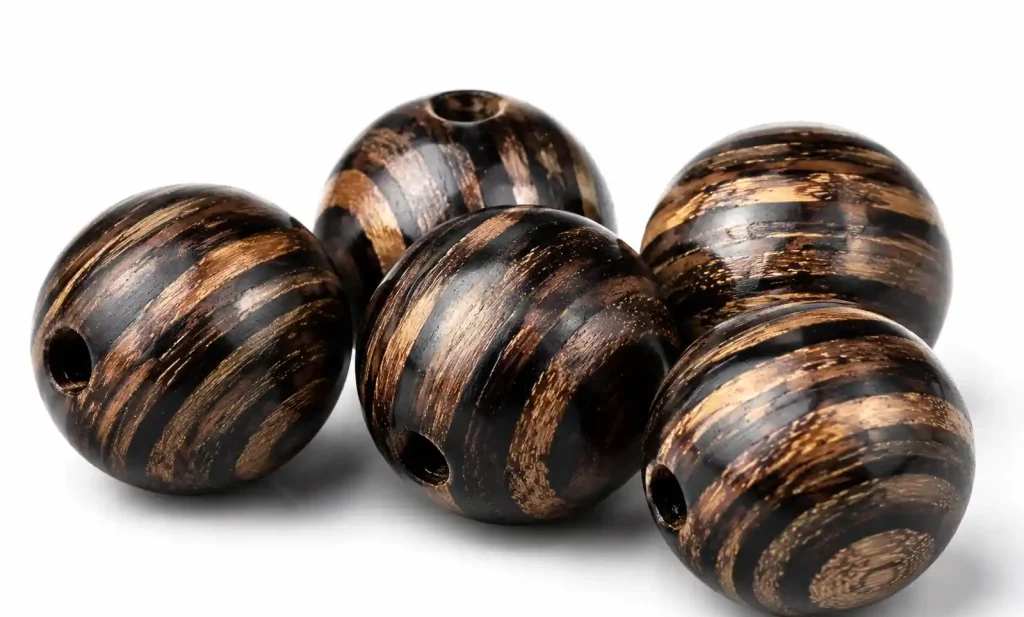 Macassar ebony wooden beads displaying dramatic black and tan natural striping patterns