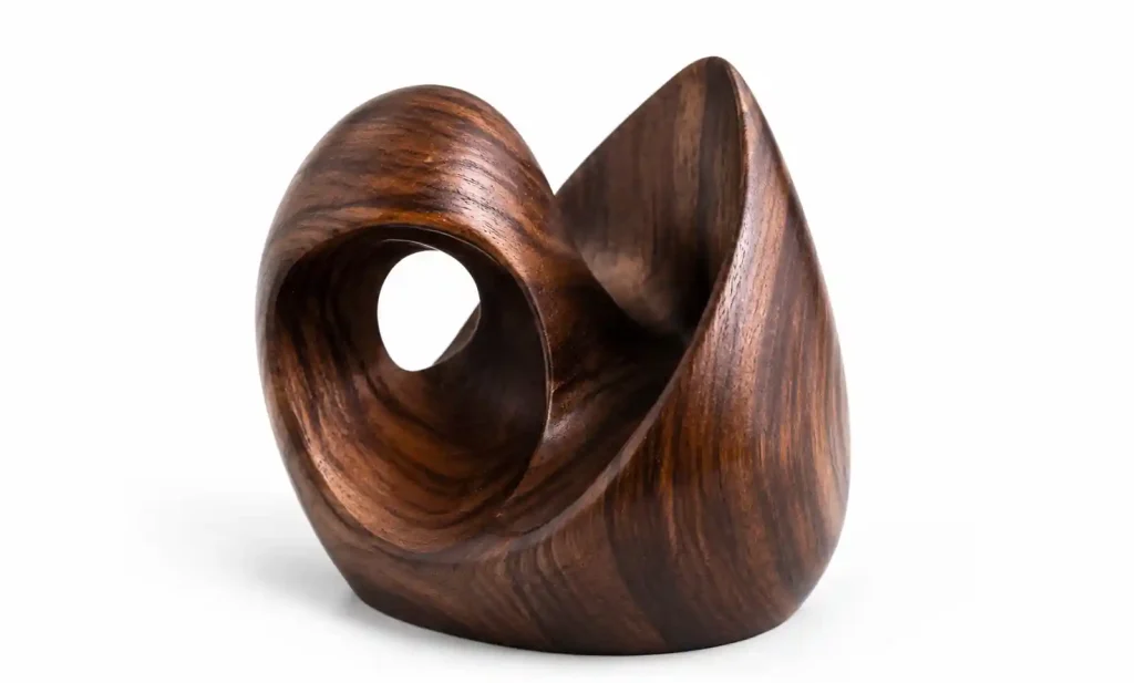 Modern abstract wooden sculpture on minimalist office desk
