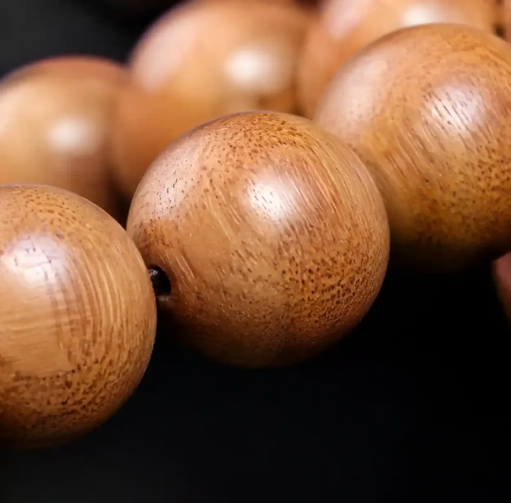 close up of sandalwood beads showing natural grain patterns and authentic wood texture
