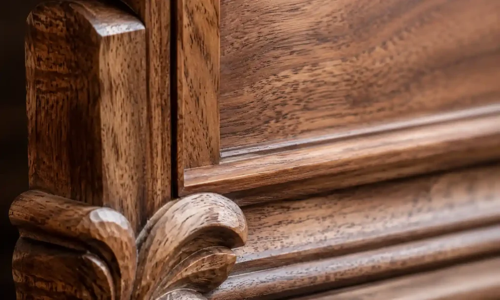 Close-up detail of handcarved wood showing grain texture and tool marks