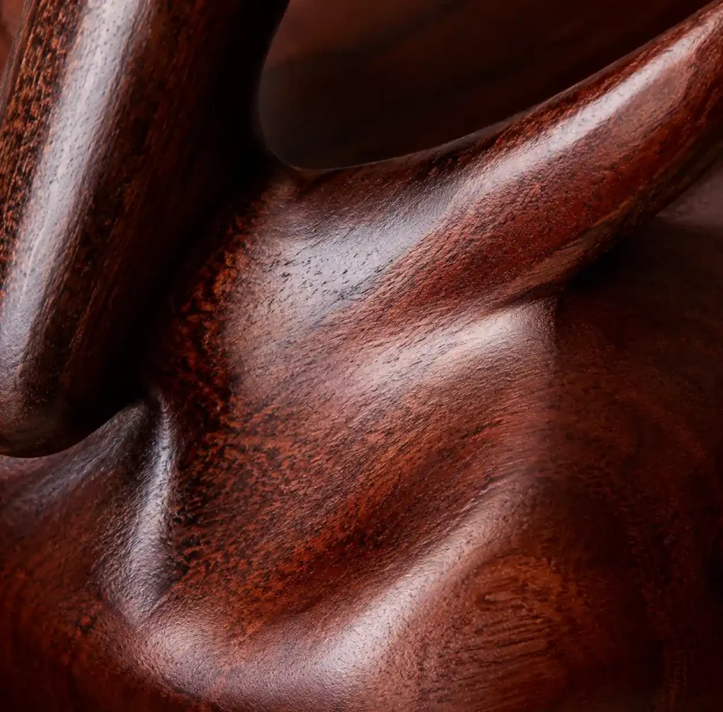 close up of premium hardwood carving showing fine grain and polished finish
