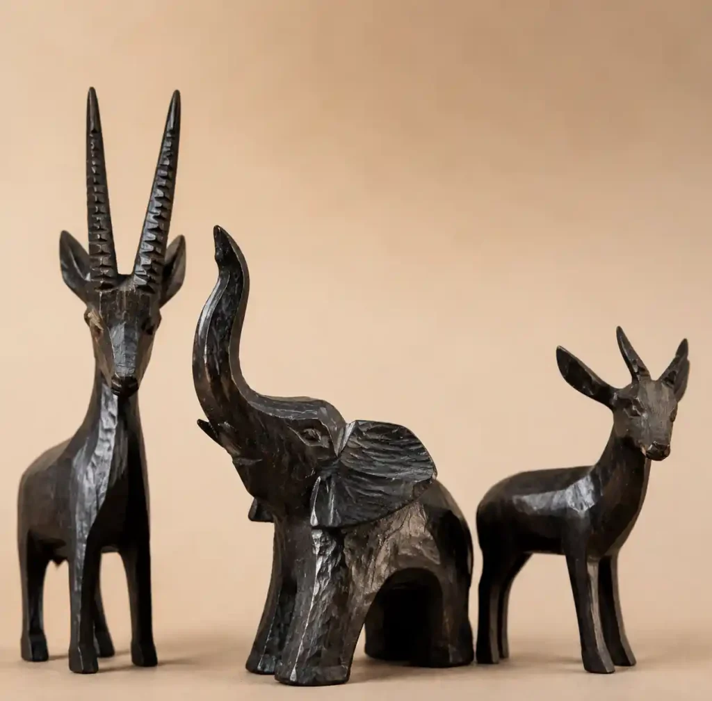 african style wooden elephant and antelope sculptures showing traditional carving aesthetic